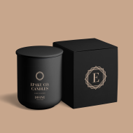 All black candle vessel with Black box. Box is embelleshed with a golden symbol, that has an E in the middle of the symbol. All of this is on a golden beige background