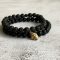 Black stone bracelet with gold Buddha charm