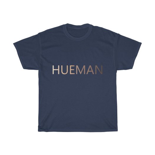 Picture of a navy blue t-shirt with the word Hueman on it that is skin-colored hues from dark skin tones to light skin tones.